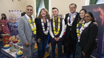 Group photo of members with decorated table